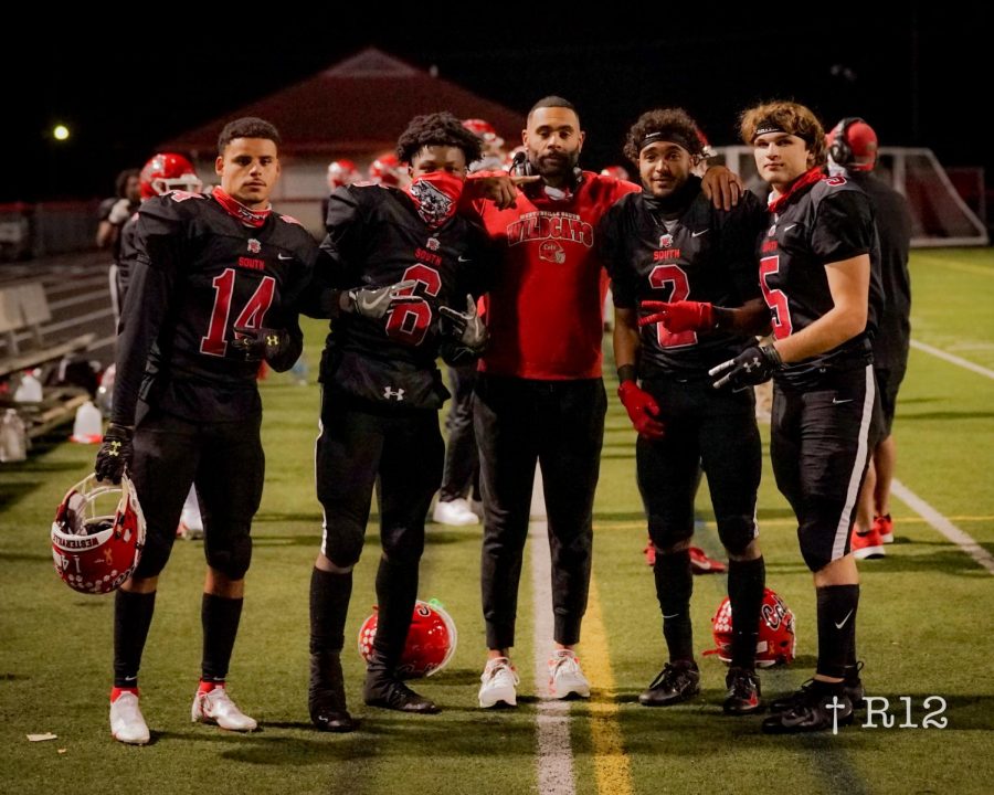 Assistant Coach Marques Parks with his Wide Receivers: Seniors Jesse Devore and Matthew Bame and Juniors Javi Wills and Kaden Saunders. The Receivers helped the Wildcats score big in their game against Watkins Memorial and move onto round 3 of the playoffs.