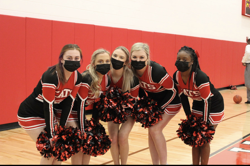 The Wildcat Senior Cheerleaders following covid protocols and wearing masks on sidelines during game against Dublin Scioto.