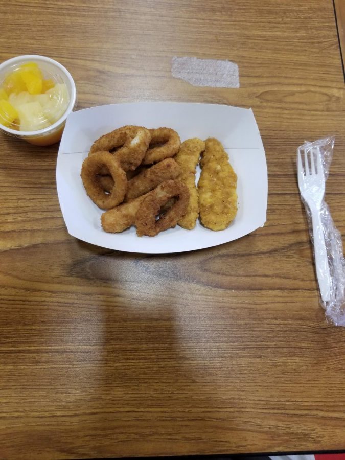  A basket of chicken tenders, onion rings, and cheese sticks complemented with a fruit cup; all obtained from the school cafeteria on Friday, Aug. 20. Basket-style lunches such as this appetizer are more prevalent with the revised lunch menu this year. Regarding the quality of the revised meals, sophomore Charlotte Reese says, “I do like them. I like the variety. I think some of the seasoning choices are a little bland; however, they are good nonetheless.”