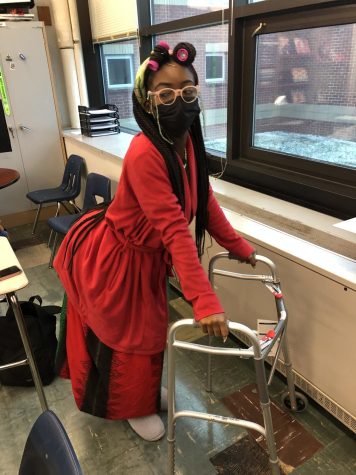Sammy Acheampong dresses as a grandma in celebration for the spirit week theme Generations on wednesday. She got the walker from a family member and made the glasses herself.  