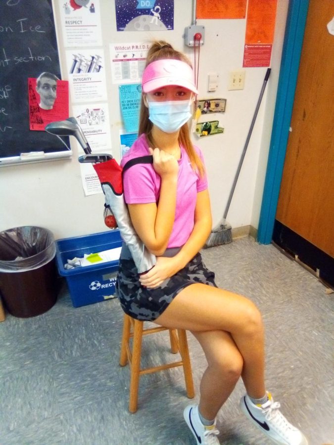 Sophomore Emily Hoelscher posing in her country club themed outfit.