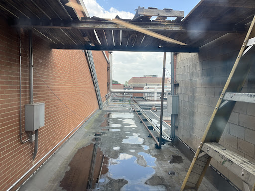 Construction at South continues with crews working to relocate and update the heating and air conditioning system, as pictured through the window here. Currently, the HVAC system is located behind a chain link fence next to the newly renovated entrances to the commons and athletic wing.  According to Principal Mike Hinze, the system is being relocated to the roof,  which will improve the aesthetics of the back entrance and lessen the  chain fence prison vibe.