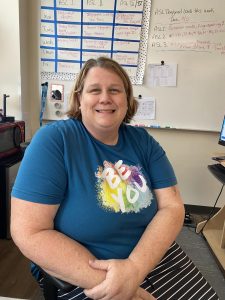 ASL teacher Lori Peters smiles for a photo after an interview with the Scribe. She is pictured in room 1404 during her 10th period study hall on Sept. 27.