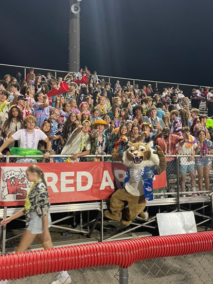 Westley The Wildcat poses with the student section at WSHS football game.