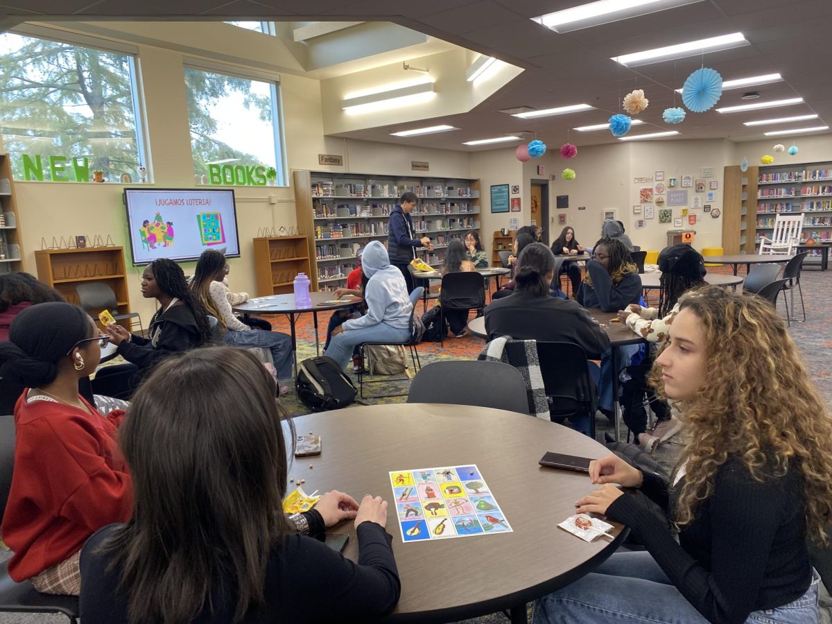 Members of the club attentively wait for another bingo card to be called. Senior Malak Elbayed said students should “Join the club to get a view of other people’s culture.”