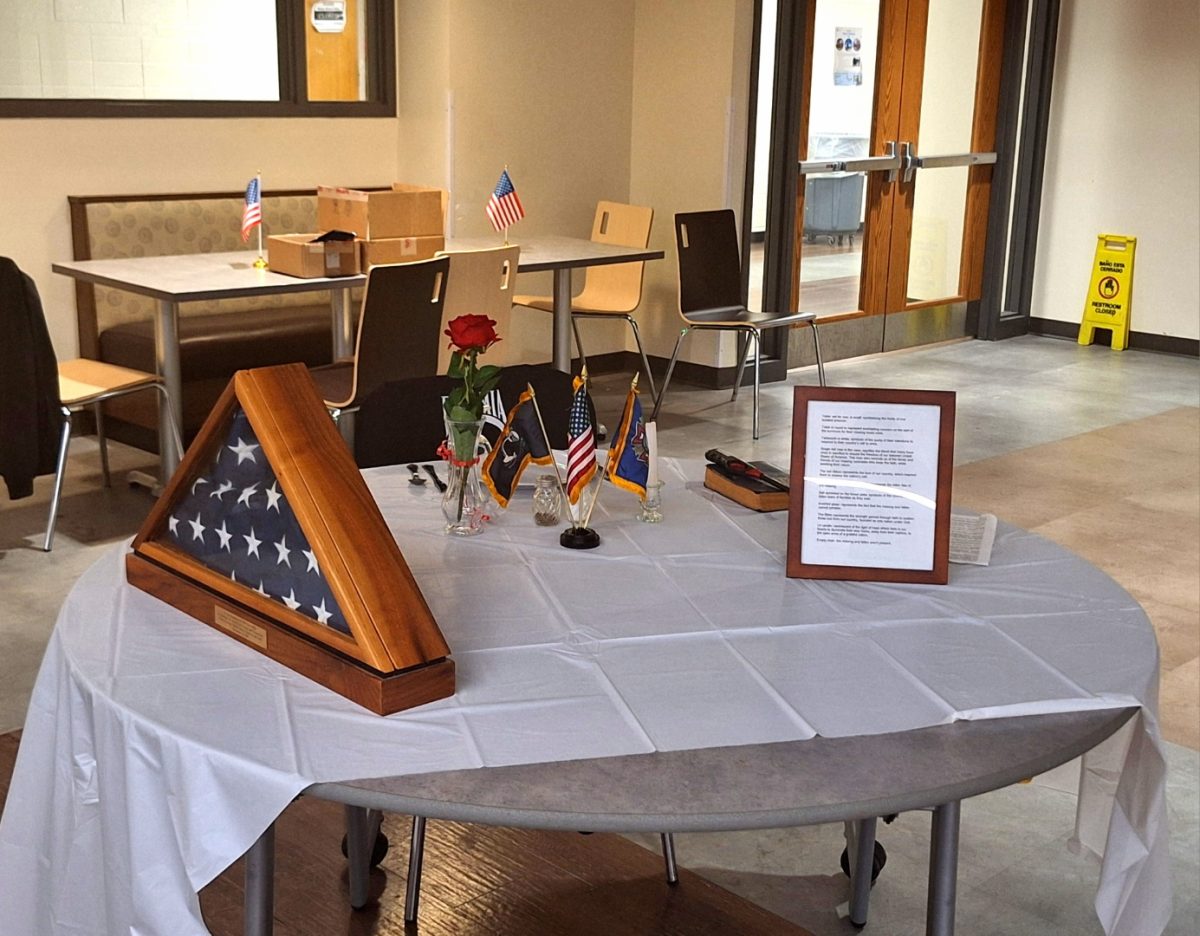 Before dinner, Ralph Smith focuses on the table (shown above), which commemorates fallen or missing soldiers in war. The round table is set with a single red rose tied with a red ribbon, a white table cloth, a christian Bible, and an American flag. The somber table is complete with an empty chair for the missing or fallen soldier.