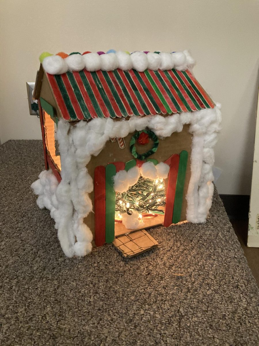 Mrs. Peters, an ASL teacher at Westerville South, showcased the festive gingerbread house created entirely by her advisory class for the Caring and Sharing competition. The event celebrates student creativity while supporting families in need during the holiday season.