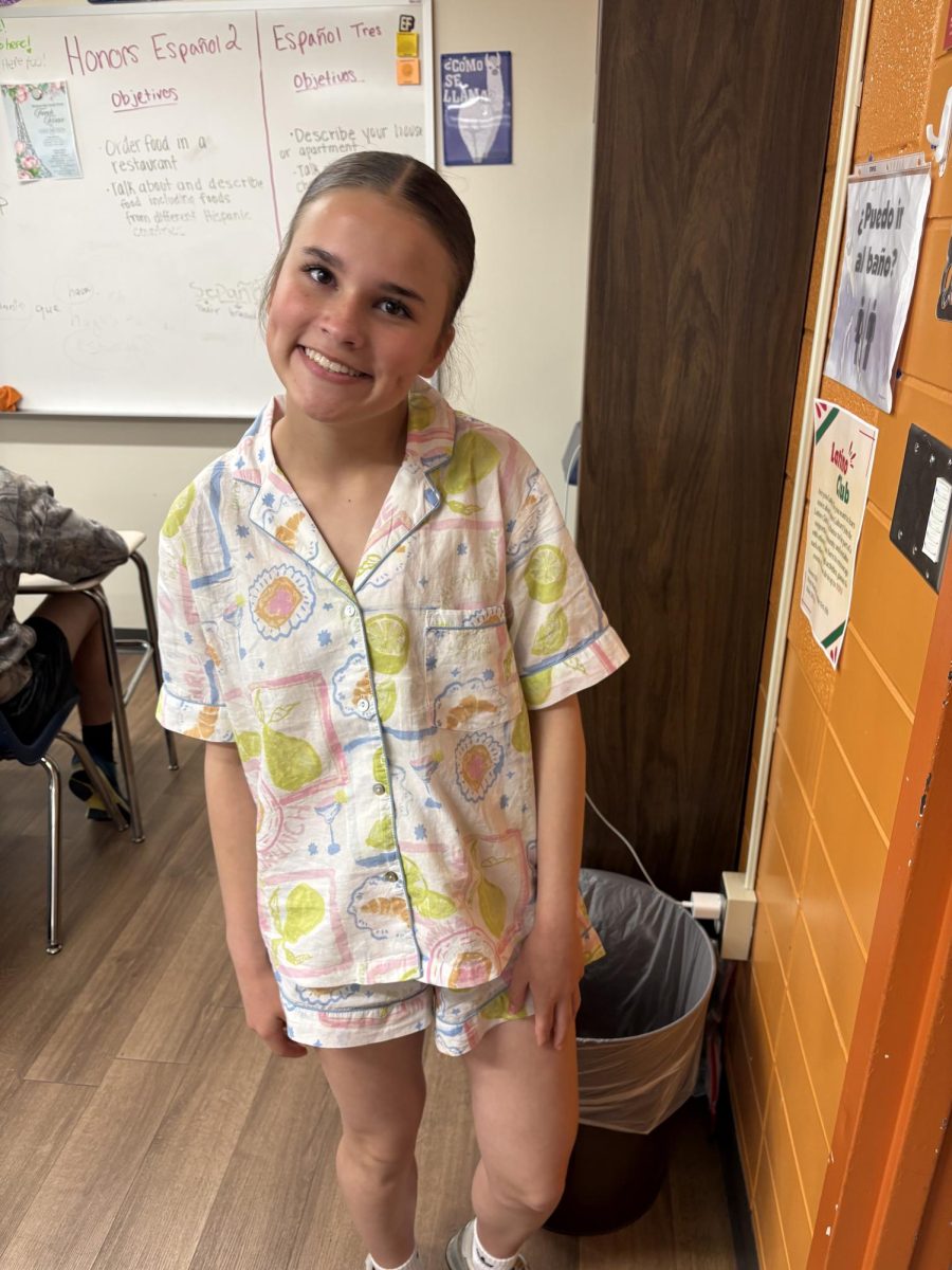 Freshman Emma Kantner Is wearing a colorful pajama set, showcasing her school spirit for prom week
