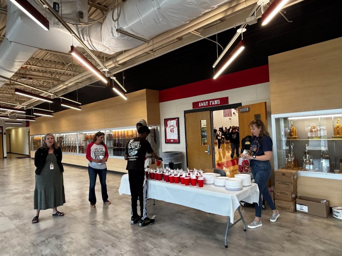 Students going to the Culture Fair on Apr. 25 meet Culture Club volunteers and advisors at the entrance. handing out plates and cups. Inside, samples of the foods and clothing of many African, Asian and Middle Eastern cultures. 