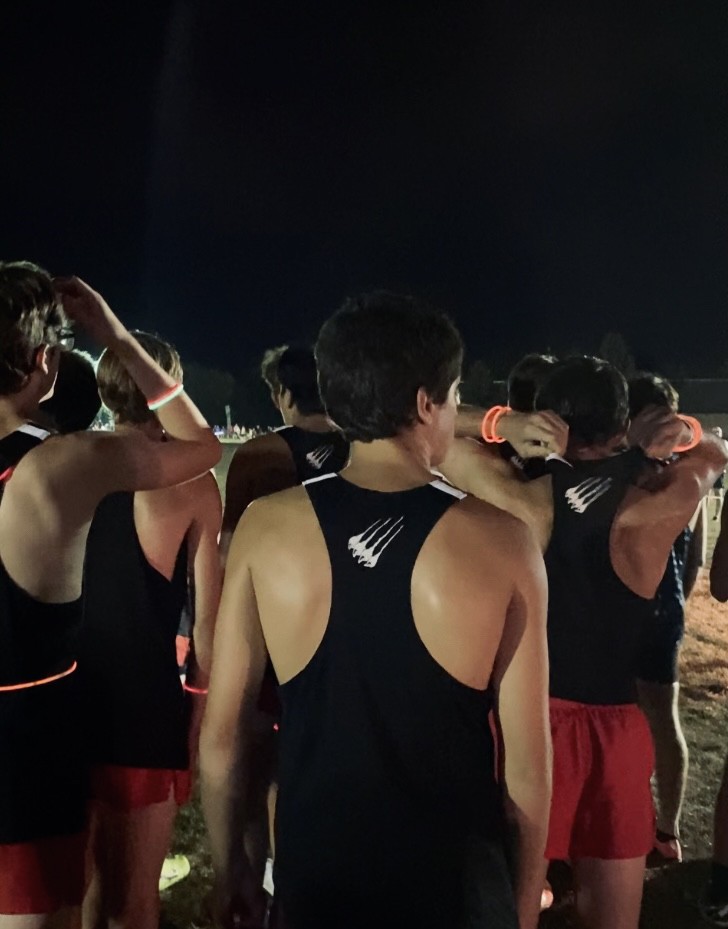 The Westerville South Boys Varsity Cross Country Team getting ready to begin their night race at Dublin Jerome with glow sticks around their bodies to light things up