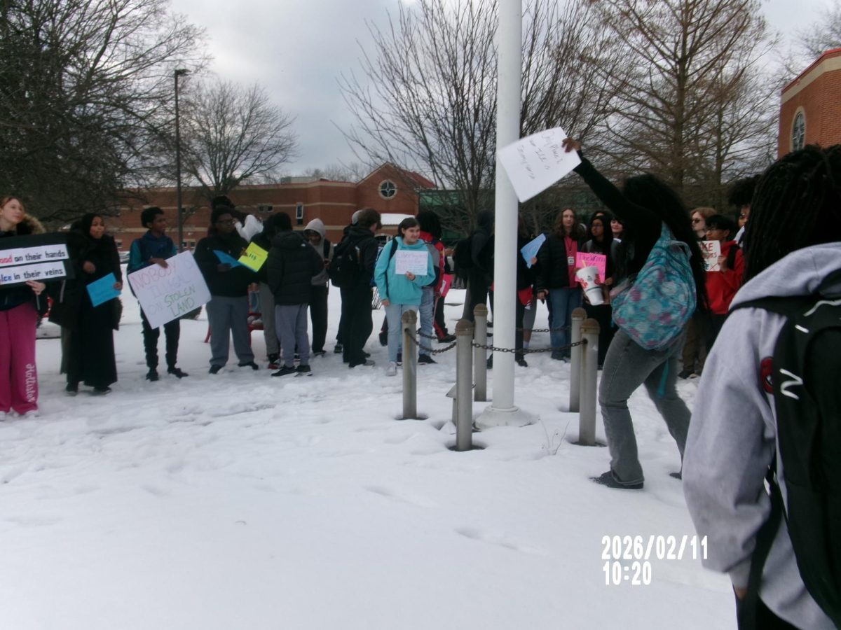 Students came out and first gathered around the flagpole at the front of the building to listen to student speakers before walking around the school. The flag pole is a symbolic location, serving as a gathering point for many previous protests at South. Photo by Sumira Adhikari.